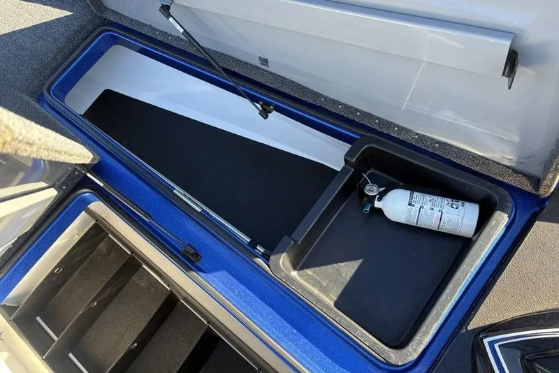 Slide: The Image of 2021 Caymas CX20 storage compartment with fire extinguisher, featuring blue and black interior. - 22