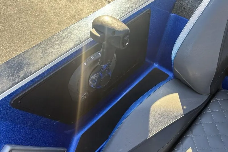 Slide: The Image of 2021 Caymas CX20 boat throttle control, blue interior, and gray seat detail. - 23