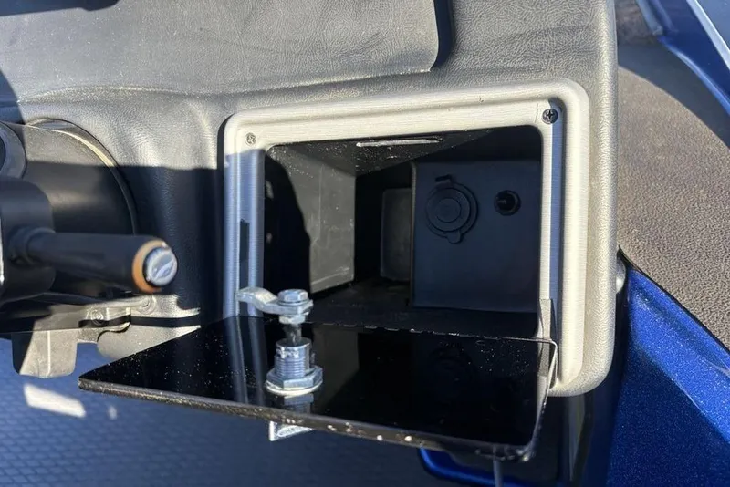 Slide: The Image of Open storage compartment in 2021 Caymas CX20 boat dashboard. - 26