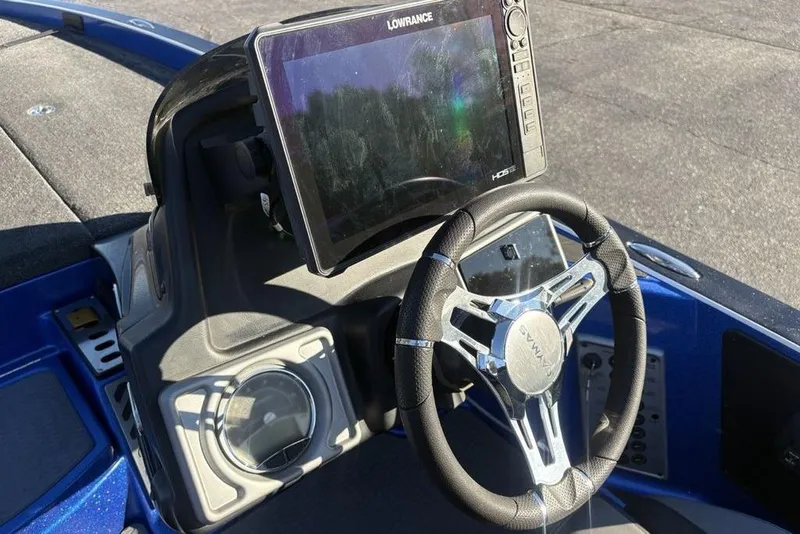 Slide: The Image of 2021 Caymas CX20 boat dashboard with Lowrance HDS display and steering wheel. - 28