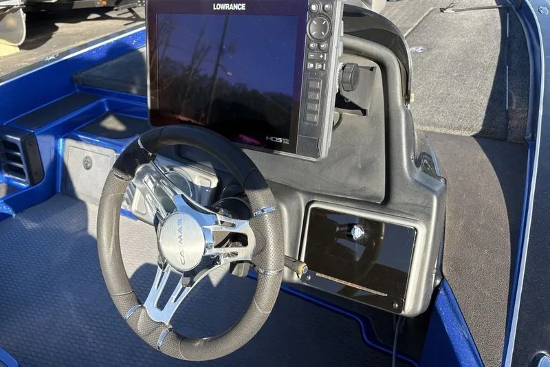 Slide: The Image of 2021 Caymas CX20 boat dashboard with Lowrance HDS12 display and steering wheel. - 29