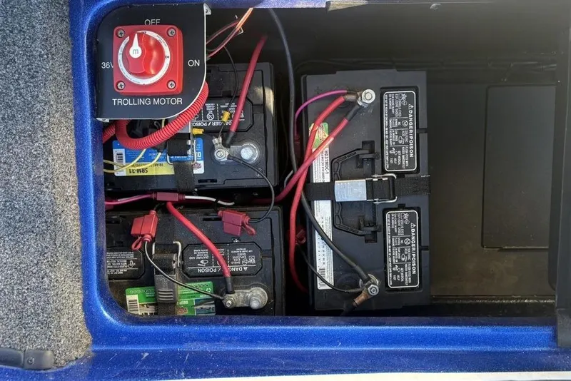 Slide: The Image of 2021 Caymas CX20 boat battery compartment with trolling motor switch and wiring. - 33