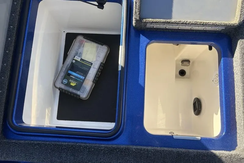 Slide: The Image of 2021 Caymas CX20 boat storage compartments with tackle box, featuring blue and white interior. - 34