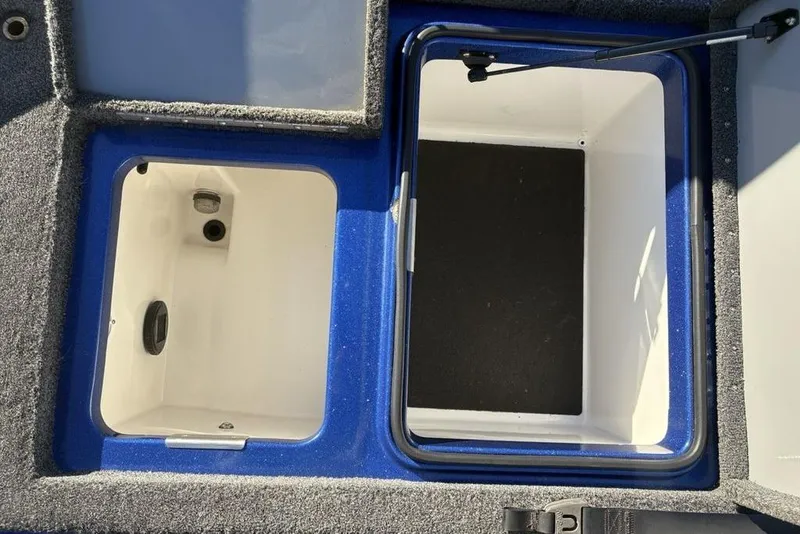 Slide: The Image of 2021 Caymas CX20 boat storage compartments with blue and white interior. - 37