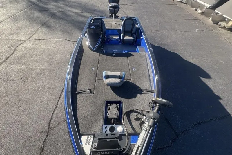 Slide: The Image of 2021 Caymas CX20 bass boat with Garmin electronics on a paved surface. - 38