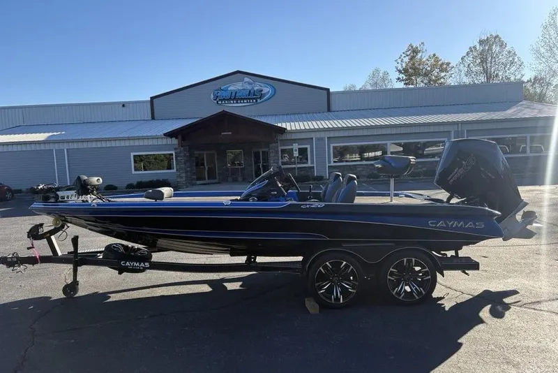 Slide: The Image of 2021 Caymas CX20 boat on trailer outside dealership, sunny day. - 40