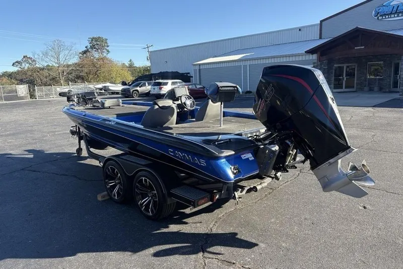 Slide: The Image of 2021 Caymas CX20 boat with powerful outboard motor, parked outdoors on a sunny day. - 5