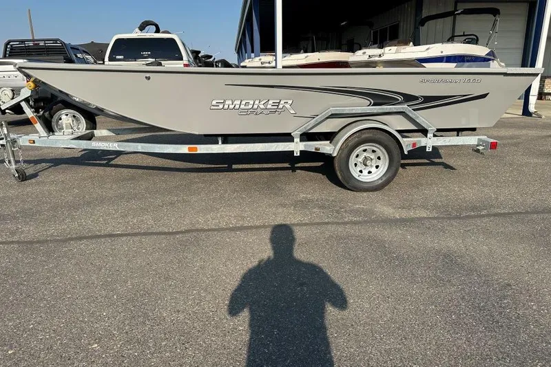 Slide: The Image of 2025 Smoker Craft Sportsman 1660 boat on trailer, parked outdoors. - 1