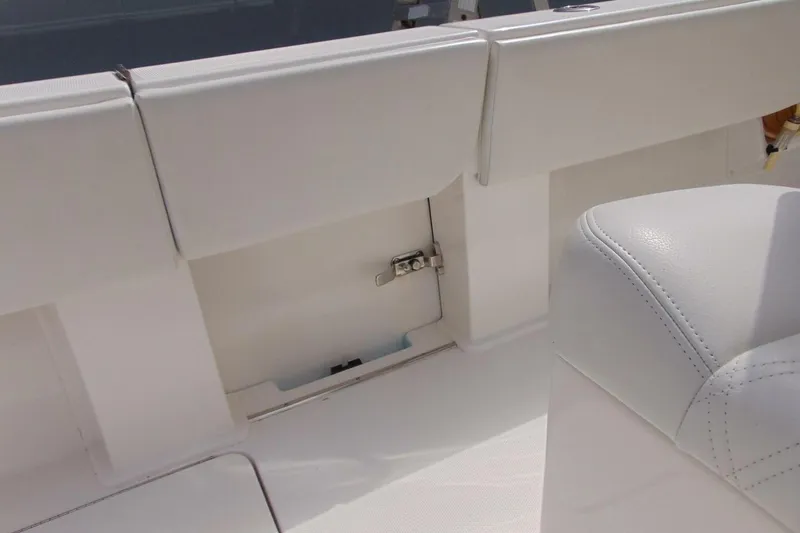 Slide: The Image of 2020 Invincible 36 Open boat interior with white seating and storage compartment. - 15