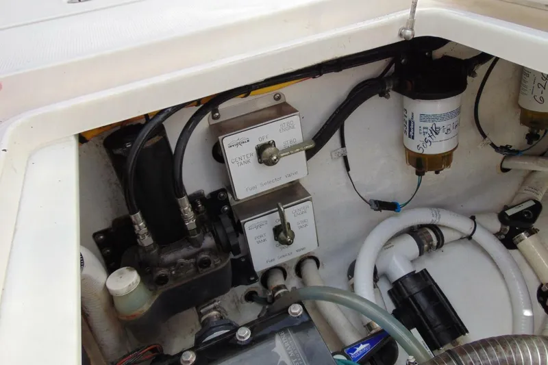 Slide: The Image of Engine compartment of a 2020 Invincible 36 Open boat, showing fuel selector valves and hoses. - 19
