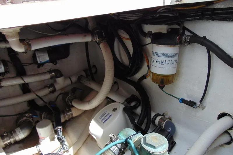 Slide: The Image of Engine compartment of 2020 Invincible 36 Open boat, showing hoses and filter system. - 20