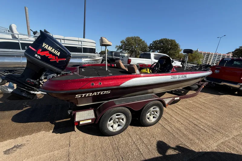 Slide: The Image of 2000 Stratos 20SS Extreme boat with powerful outboard motor, parked on trailer. - 11