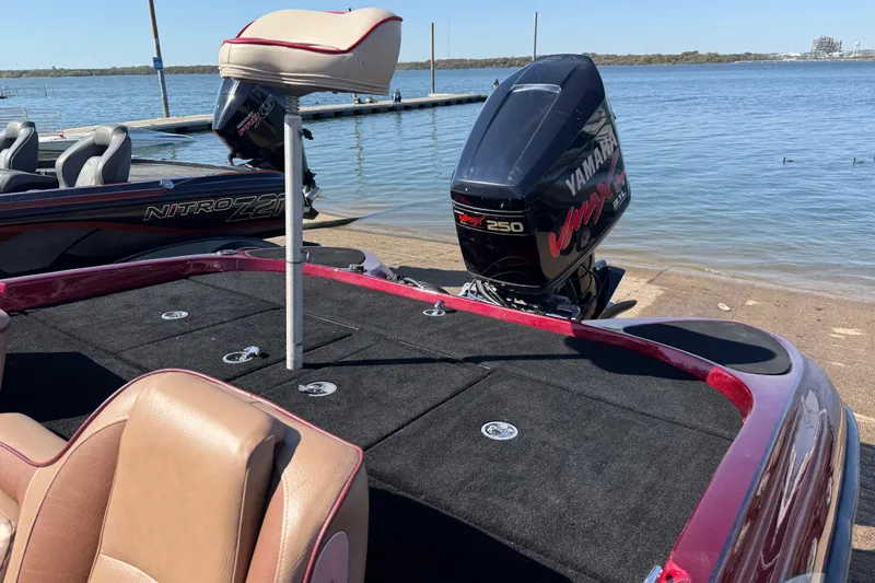 Slide: The Image of Foot pedal in a 2000 Stratos 20SS Extreme boat, with carpeted interior and mesh storage pocket. - 28