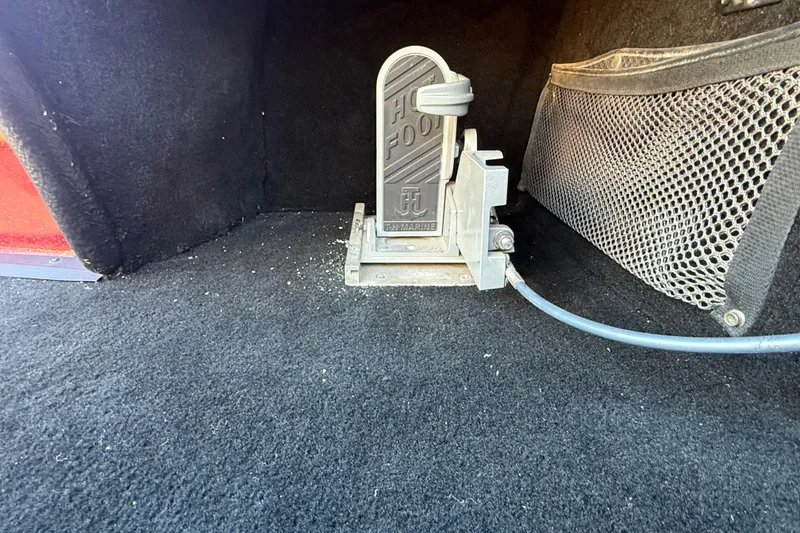 Slide: The Image of Open storage compartment in a 2000 Stratos 20SS Extreme boat, featuring a maroon exterior. - 35