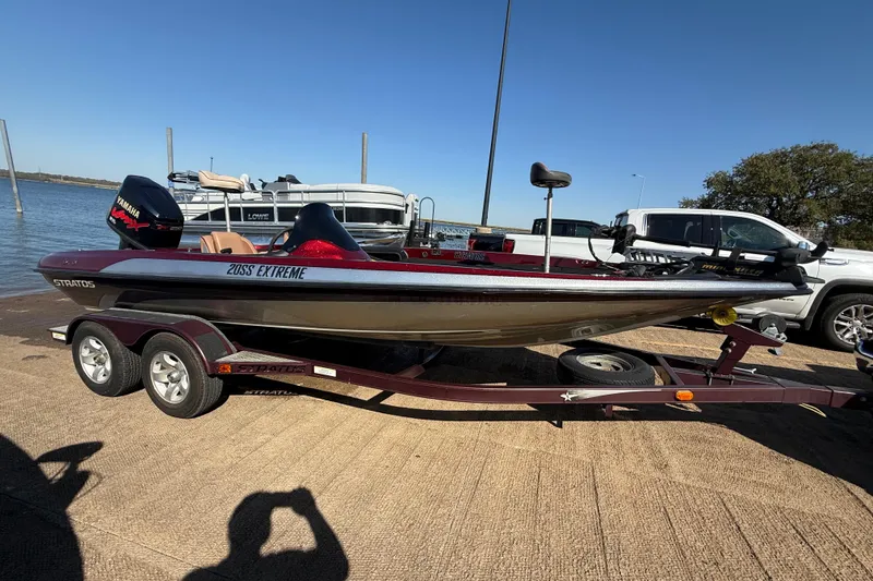 Slide: The Image of 2000 Stratos 20SS Extreme boat on trailer by lakeside, featuring Yamaha engine. - 4