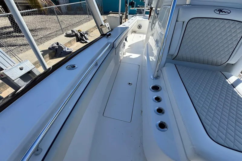 Slide: The Image of 2024 Valhalla V-29 Hybrid boat interior with quilted seating and rod holders. - 22
