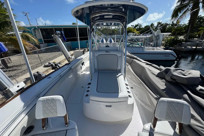 Slide: The Image of 2024 Valhalla Boatworks V-29 Hybrid, sleek design, luxurious seating, docked under clear blue sky. - 25