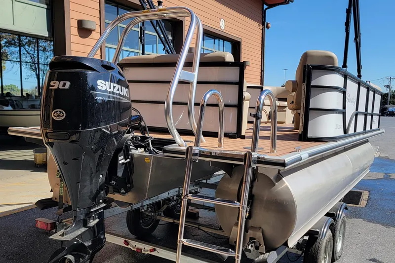 Slide: The Image of 2024 Bentley Pontoons Legacy Cruise with Suzuki 90 engine, parked outside a building. - 3