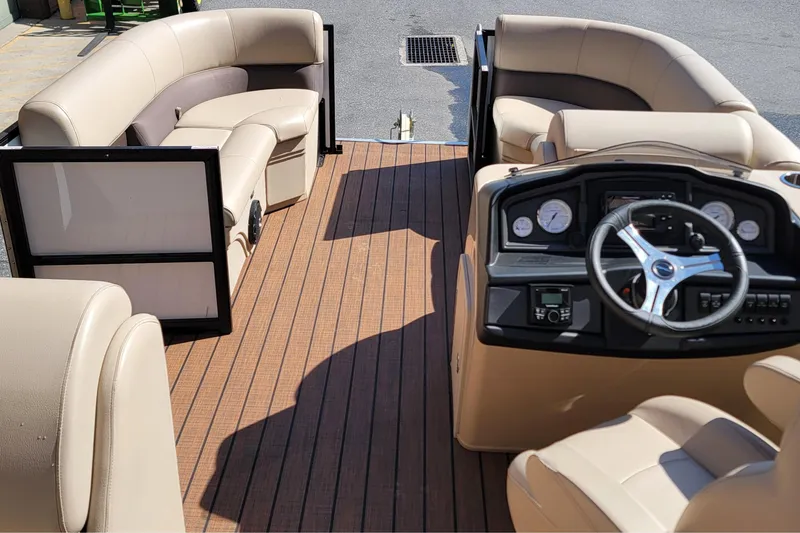 Slide: The Image of 2024 Bentley Pontoons Legacy Cruise interior with beige seating and modern dashboard. - 6