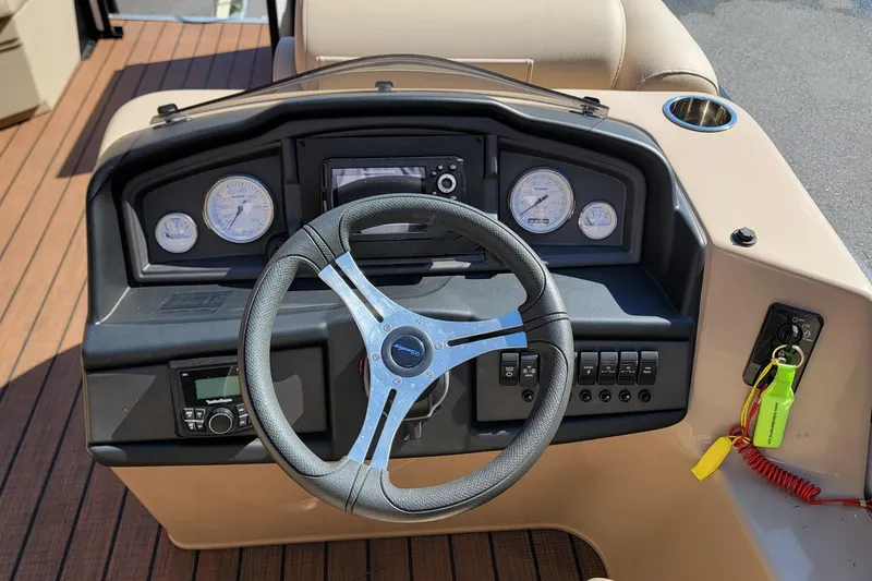 Slide: The Image of 2024 Bentley Pontoons Legacy Cruise dashboard with steering wheel and control panel. - 8