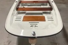Slide: The Image of 1993 Boston Whaler Sport 11 boat with wooden accents, viewed from the front. - 8