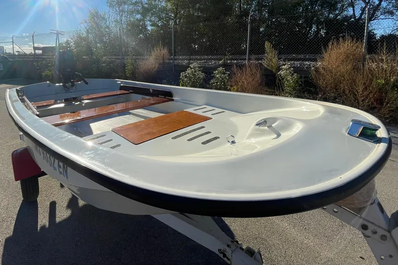 Slide: The Image of 1993 Boston Whaler Sport 11 boat on trailer, sunny day, outdoor setting. - 9
