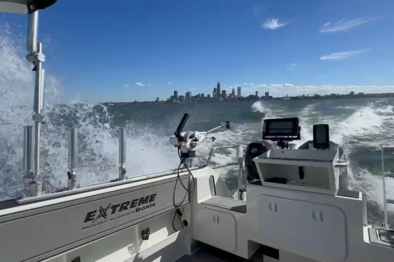 Slide: The Image of 2023 Extreme Boats 695 Game King navigating waves with city skyline in background. - 11
