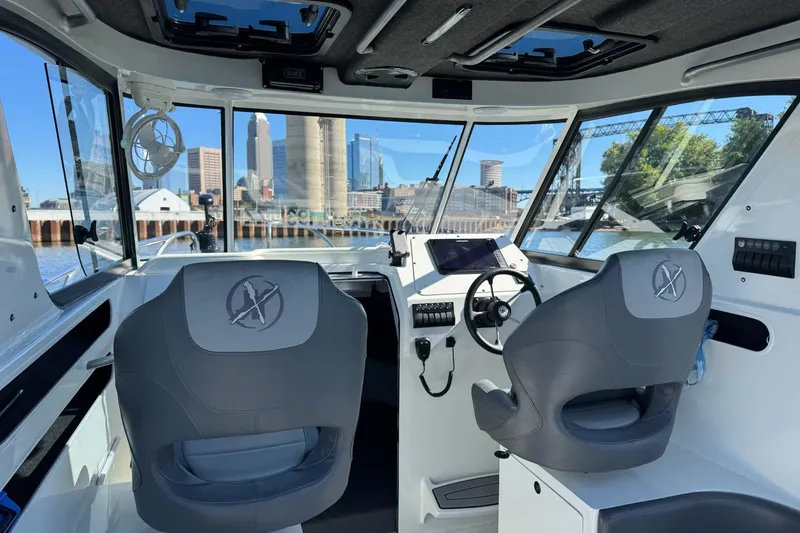 Slide: The Image of 2023 Extreme Boats 695 Game King interior with city skyline view through windows. - 16