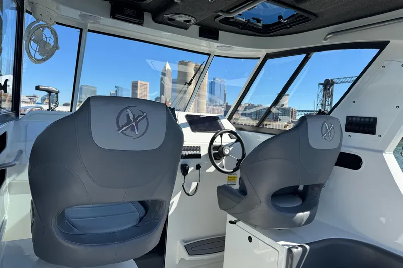 Slide: The Image of 2023 Extreme Boats 695 Game King interior with city skyline view through windows. - 17