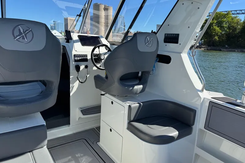 Slide: The Image of 2023 Extreme Boats 695 Game King interior with modern helm and seating. - 18
