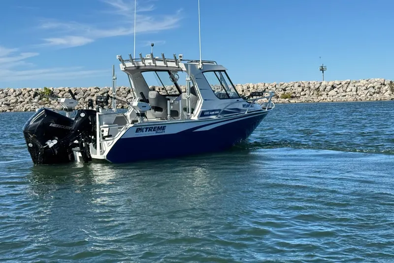 Slide: The Image of 2023 Extreme Boats 695 Game King on water, showcasing sleek design and powerful engine. - 2