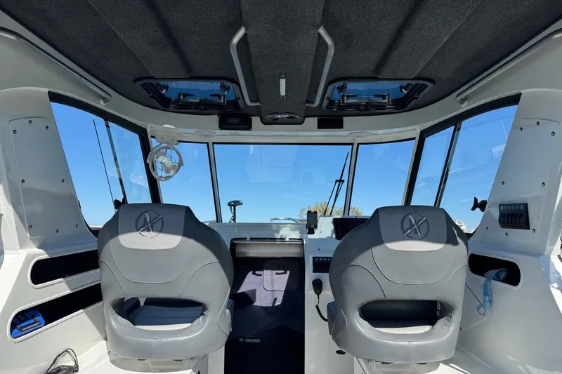 Slide: The Image of Interior of 2023 Extreme Boats 695 Game King, featuring dual seats and modern controls. - 21