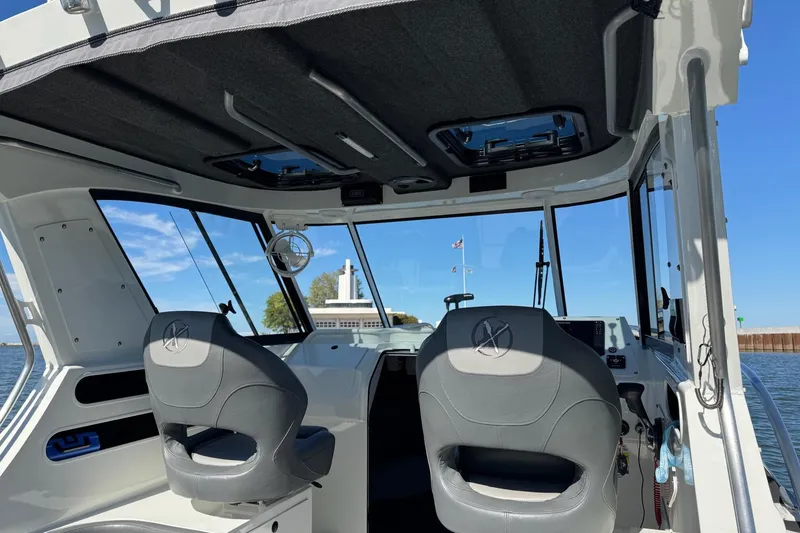 Slide: The Image of Interior view of 2023 Extreme Boats 695 Game King, featuring modern seating and dashboard. - 24