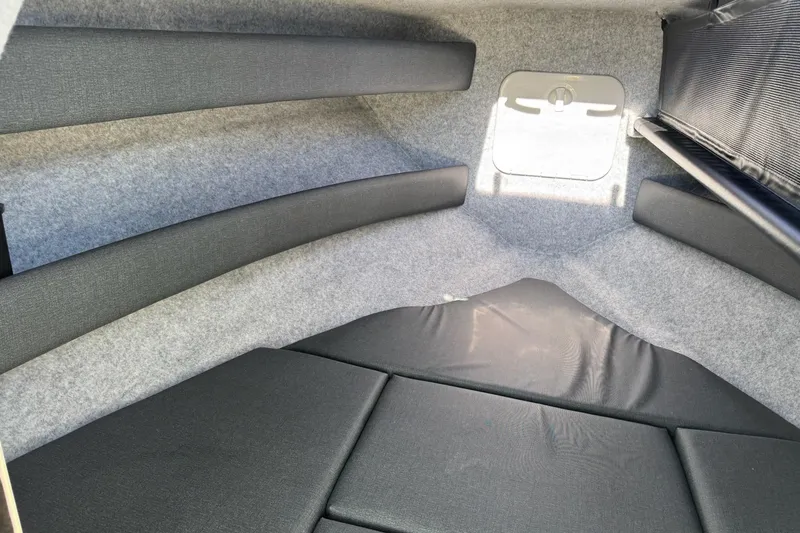 Slide: The Image of Interior cabin of 2023 Extreme Boats 695 Game King, featuring cushioned seating and compact design. - 29