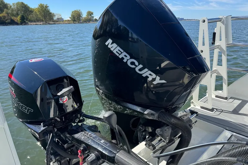 Slide: The Image of 2023 Extreme Boats 695 Game King with Mercury outboard engines on a lake. - 31