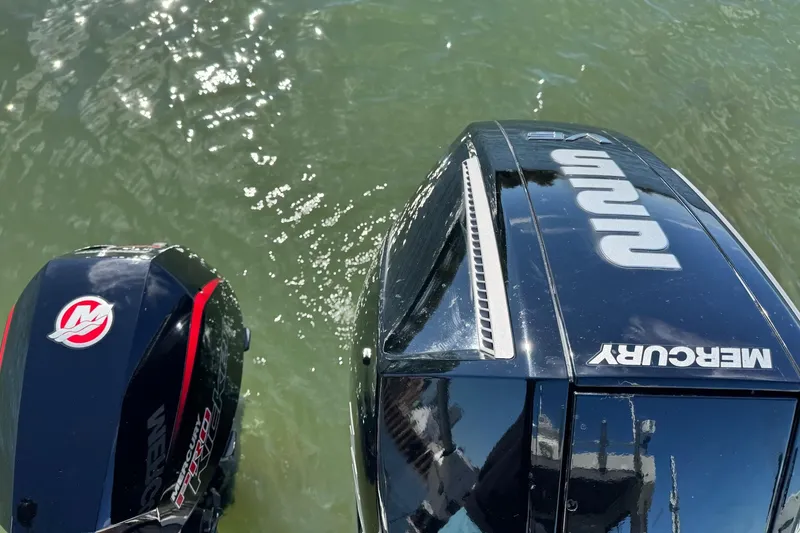 Slide: The Image of Outboard motors on 2023 Extreme Boats 695 Game King in water. - 33