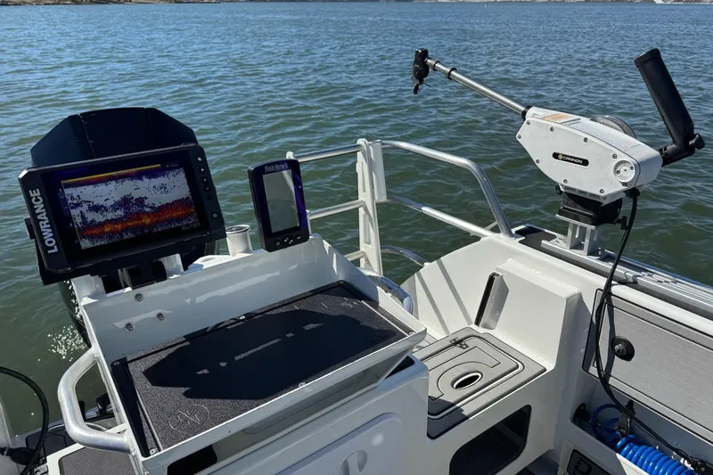 Slide: The Image of 2023 Extreme Boats 695 Game King with fishing equipment and navigation screens on a calm sea. - 8