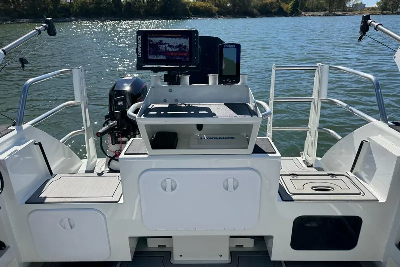 Slide: The Image of 2023 Extreme Boats 695 Game King, fishing setup with electronics on a calm lake. - 9