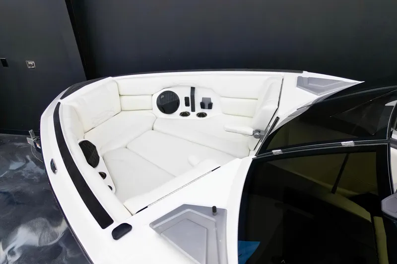 Slide: The Image of 2023 Malibu Wakesetter 26 LSV boat interior with white seating and cup holders. - 12