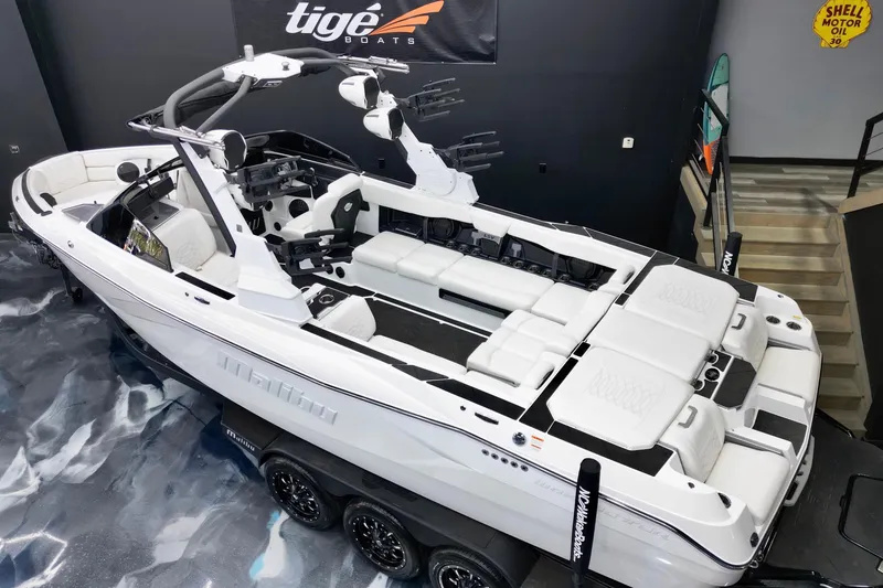 Slide: The Image of 2023 Malibu Wakesetter 26 LSV boat in showroom, featuring sleek design and spacious seating. - 19