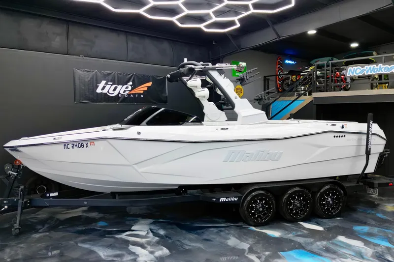 Slide: The Image of 2023 Malibu Wakesetter 26 LSV boat on trailer in showroom with modern lighting. - 3