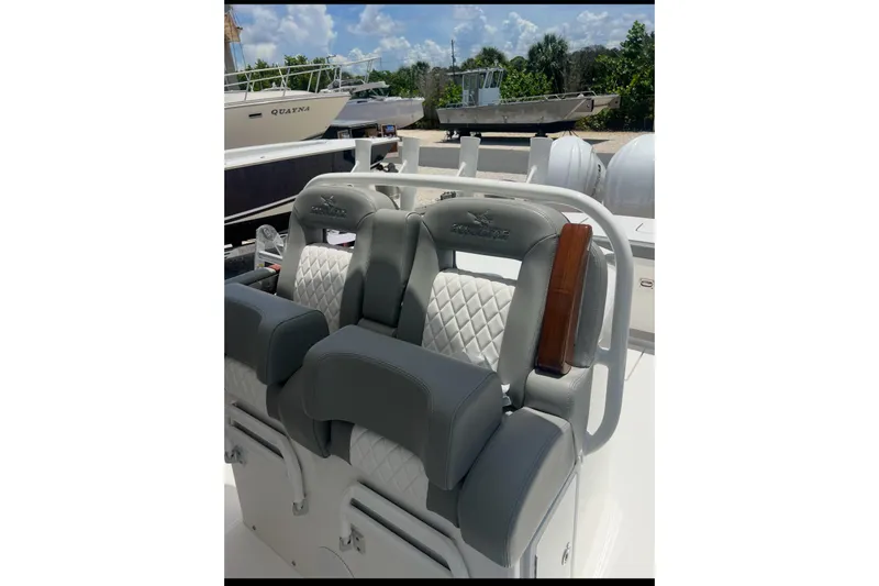 Slide: The Image of 2024 Regulator 34 C boat seats with quilted design and sleek gray upholstery. - 2