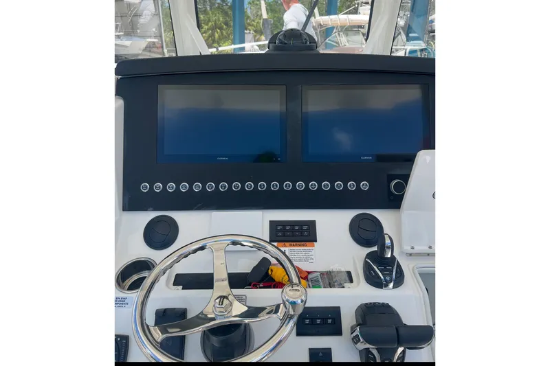 Slide: The Image of 2024 Regulator 34 c helm with dual Garmin displays and modern controls. - 4