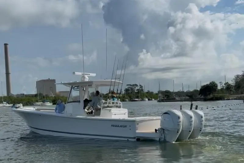 Slide: The Image of 2024 Regulator 34 C boat on water with twin engines and fishing rods. - 6