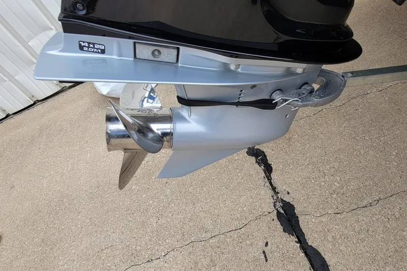 Slide: The Image of Close-up of a 2022 Bass Tracker PRO TEAM 190 boat propeller on concrete. - 10