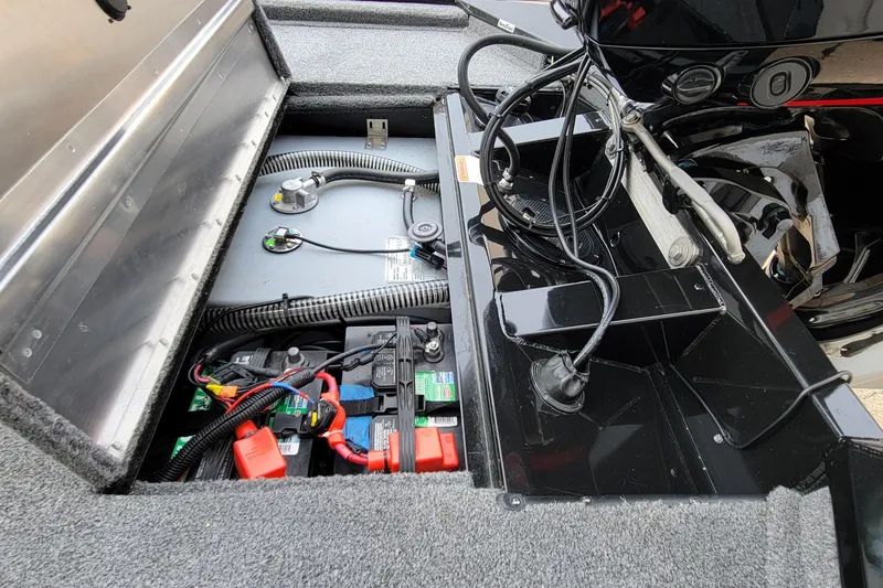 Slide: The Image of 2022 Bass Tracker PRO TEAM 190 boat battery compartment with wiring and components. - 28