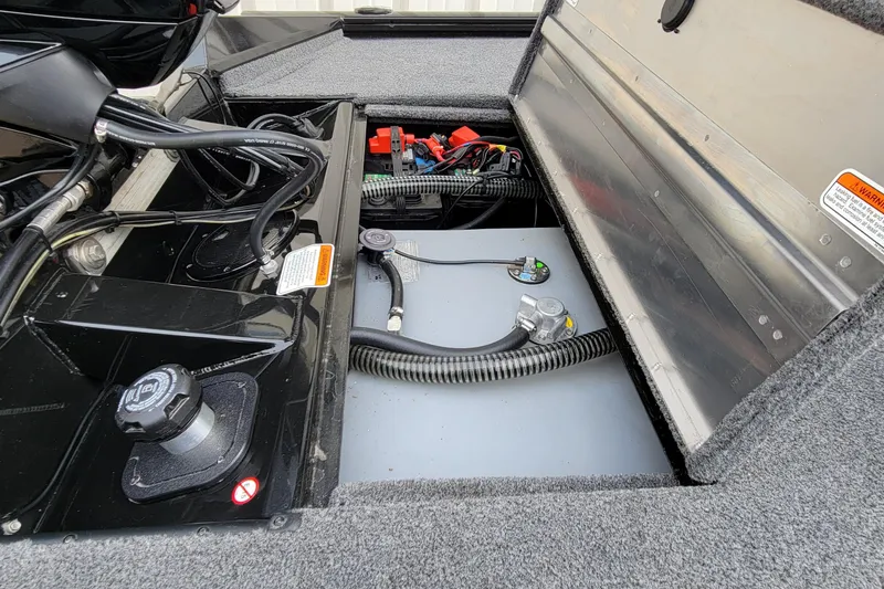 Slide: The Image of 2022 Bass Tracker PRO TEAM 190 boat engine compartment with wiring and components. - 29