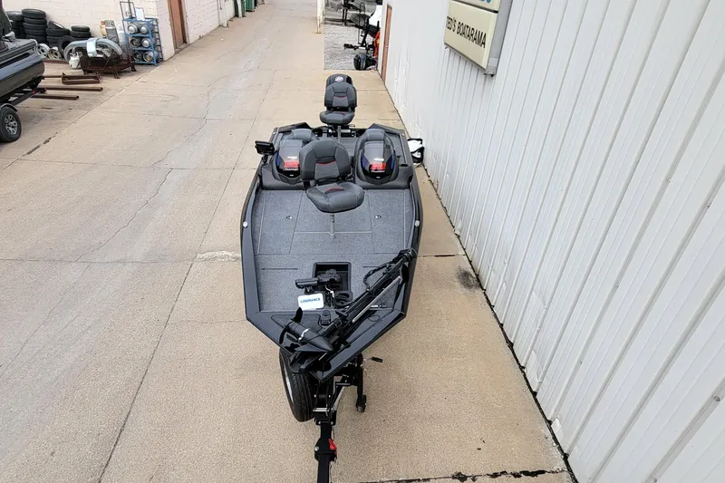 Slide: The Image of 2022 Bass Tracker PRO TEAM 190 boat parked on concrete near a building. - 36