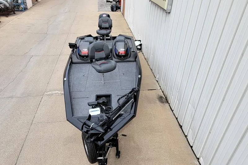 Slide: The Image of 2022 Bass Tracker PRO TEAM 190 boat with seating and equipment, parked on pavement. - 38