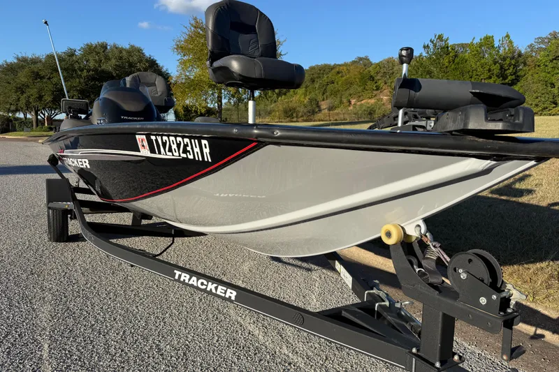 Slide: The Image of 2020 Tracker Pro Team 175 boat on trailer, parked outdoors on a sunny day. - 20